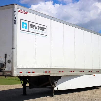 Newport dry van trailer with the company logo beneath a bright blue sky