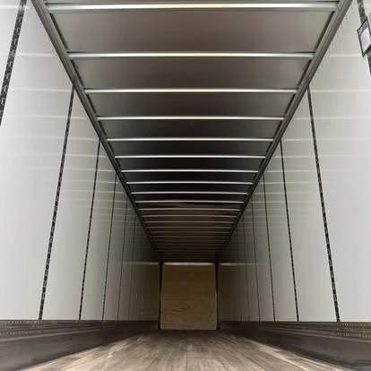 View through the open rear doors into a Newport dry van trailer