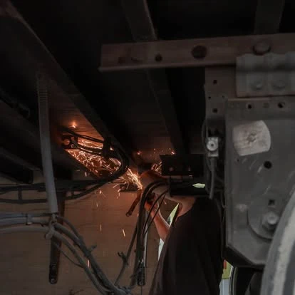 Repair work underway beneath a trailer